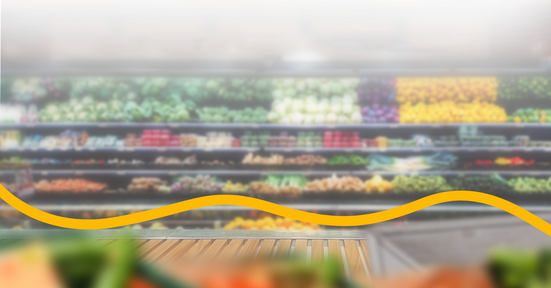 A blurred view of a grocery store produce section with colorful fruits and vegetables on display, and a yellow wavy line across the lower part of the image. GREENHOUSE Goodness A blurred view of a grocery store produce section with colorful fruits and vegetables on display, and a yellow wavy line across the lower part of the image. GREENHOUSE Goodness