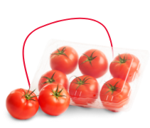 A group of bright red tomatoes, with green stems, sits in a transparent plastic container. Two tomatoes are placed in front of the container on a white surface. GREENHOUSE Goodness